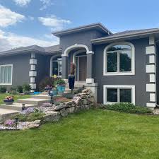 Stoughton exterior house painting project showing beautiful blue and stone facade